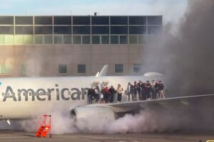 Passengers evacuate after American Airlines plane catches fire in ...