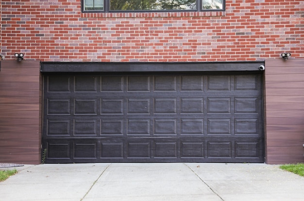 A garage door is open to a brick house. | Premium Photo