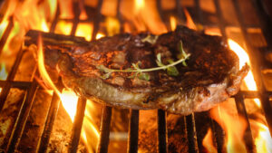 Steak and oregano on grill
