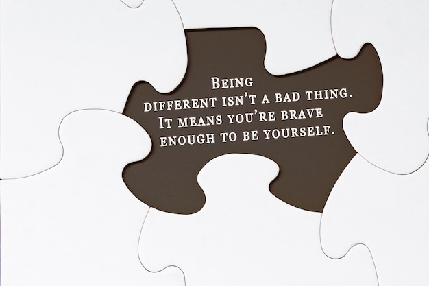 Motivational quote on white jigsaw puzzle with some missing pieces ...