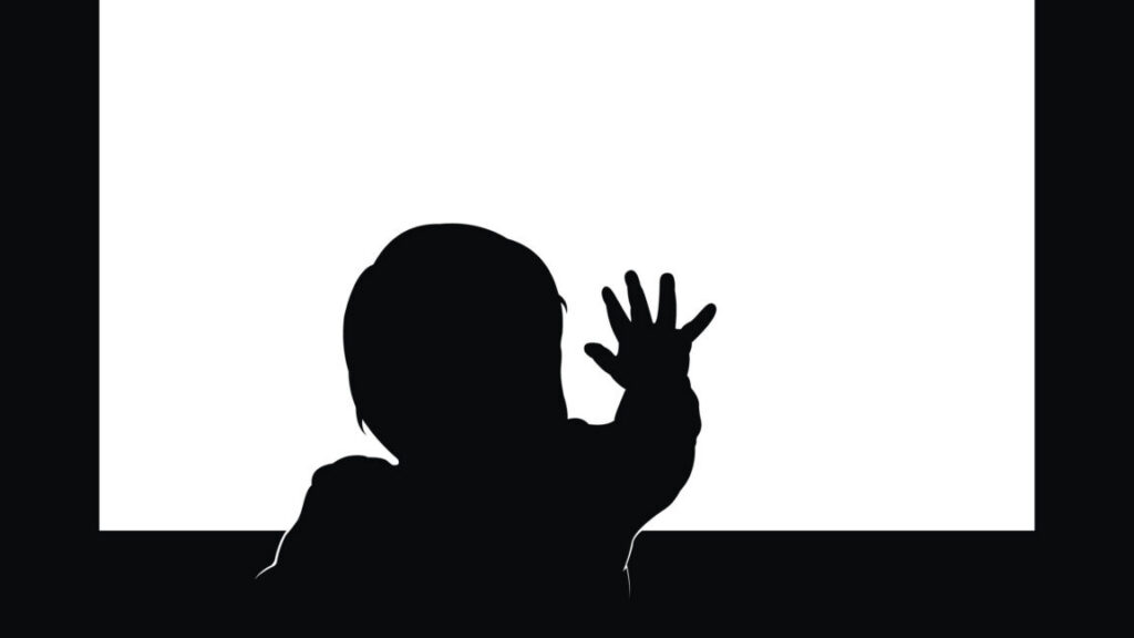 Little toddler touching blank television screen with his hand