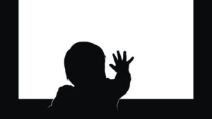 Little toddler touching blank television screen with his hand