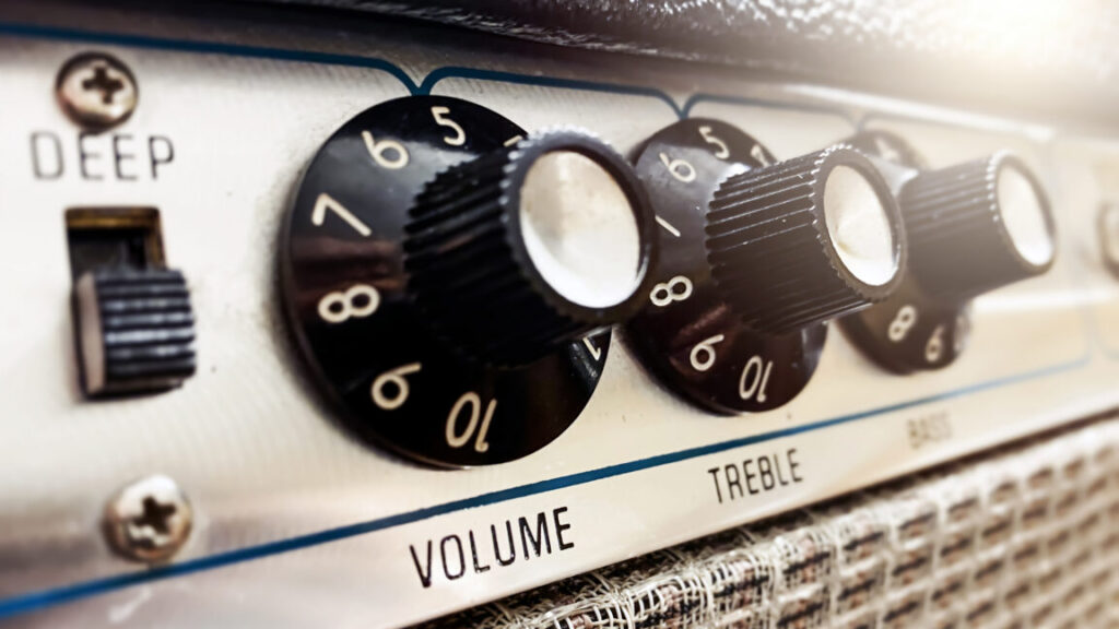 Close-up view of the knobs of an amplifier for adjusting the sound of stringed musical instruments