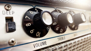 Close-up view of the knobs of an amplifier for adjusting the sound of stringed musical instruments
