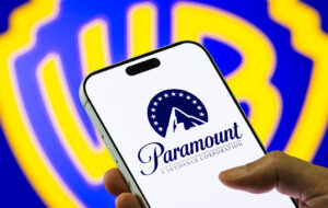 Paramount Logo on Smartphone Against Warner Bros. Discovery Background