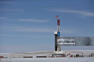 An American flag flies on top of a Unit Drilling Co. rig in the ...