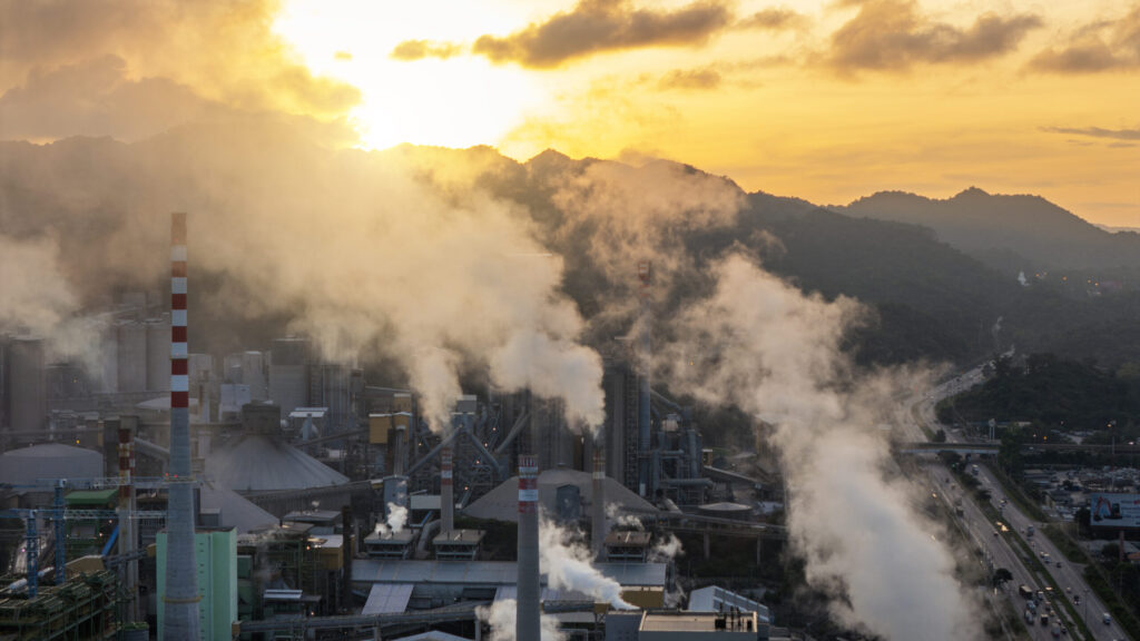 Industrial Factory Emitting Smoke During Golden Sunset