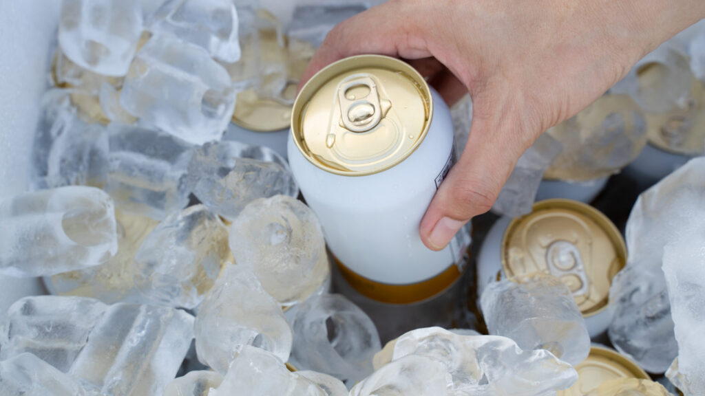 cold cans inside a cooler filled with ice
