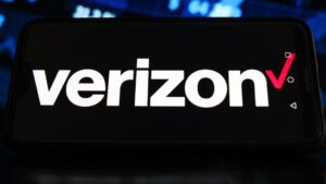In this photo illustration a Verizon logo seen displayed on